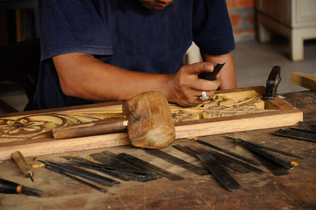 Malaysian traditional woof carving using traditional method by skilled craftsman on November 6, 2014. Craftsman using floral motifs as inspiration to express their creativity.の写真素材