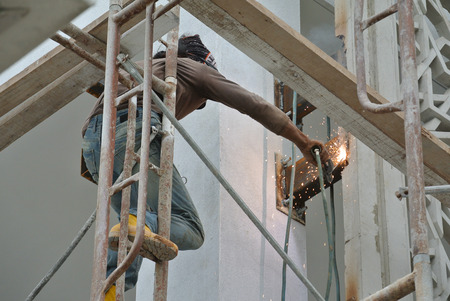 Welders taking very high risk working at high level at the construction site.のeditorial素材