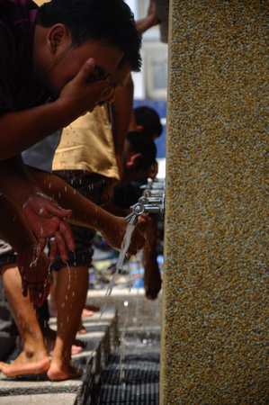 Men using the ablution of Cyberjaya Mosque in Cyberjaya, Malaysia