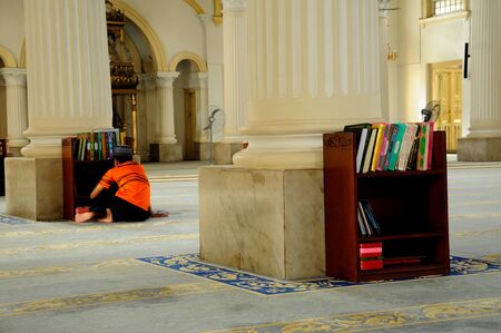 A boy reading Quran in Sultan Abu Bakar State Mosque in Johor Bharu Malaysiaのeditorial素材