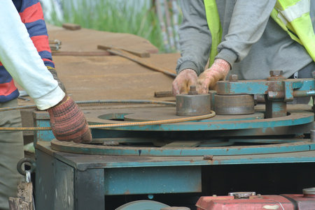 Construction workers bending the reinforcement bar at the bar bending yard in the construction site.