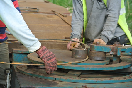 Construction workers bending the reinforcement bar at the bar bending yard in the construction site.の写真素材