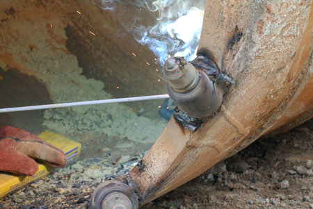 Licence welder weld bore pile auger at construction site in Malaysia on March 23, 2015