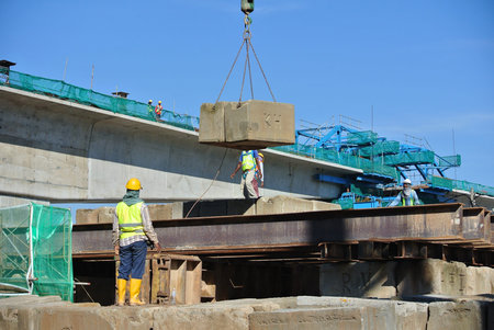 Construction workers stacking the maintain load test block at the construction site in Selangor,...