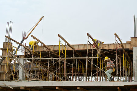 SELANGOR, MALAYSIA  NOVEMBER 25, 2014: Group of construction worker fabricating building timber beam...