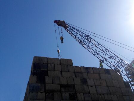 SELANGOR, MALAYSIA  APRIL 08, 2015: Construction workers stacking the maintain load test block at the construction site in Selangor, Malaysia. The block used to test the piling integrity.のeditorial素材