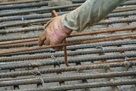 MALACCA, MALAYSIA  SEPTEMBER 17, 2015: A construction workers fabricating floor slab reinforcement bar at the construction site in Malacca, Malaysia on September 17, 2015.のeditorial素材