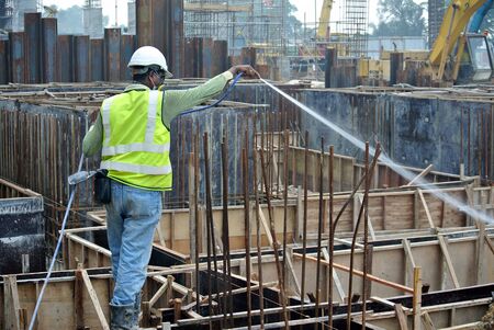 JOHOR, MALAYSIA  SEPTEMBER 28, 2015: Construction workers spraying the anti termite chemical treatment at the construction site on September 28, 2015.のeditorial素材
