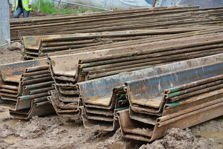 MALACCA, MALAYSIA  SEPTEMBER 15, 2015: Stack of retaining wall steel sheet pile cofferdam in the construction site in Malacca, Malaysia on September 15, 2015.のeditorial素材