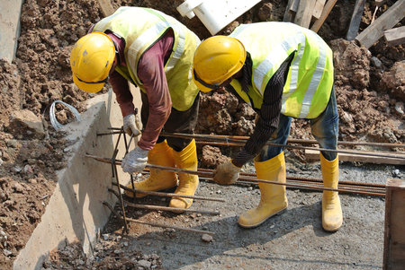 MALACCA, MALAYSIA  SEPTEMBER 22, 2015: Group of construction workers fabricating ground beam steel...