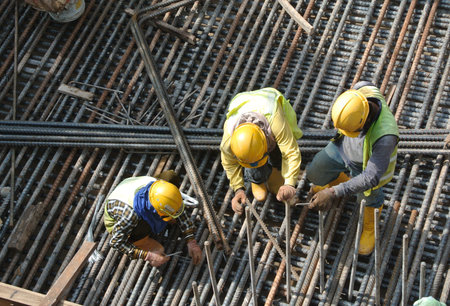 MALACCA, MALAYSIA  SEPTEMBER 22, 2015: Group of construction workers fabricating steel reinforcement...