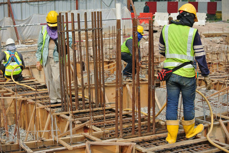 SELANGOR, MALAYSIA  OCTOBER 17, 2015: Group of construction workers fabricating ground beam timber...