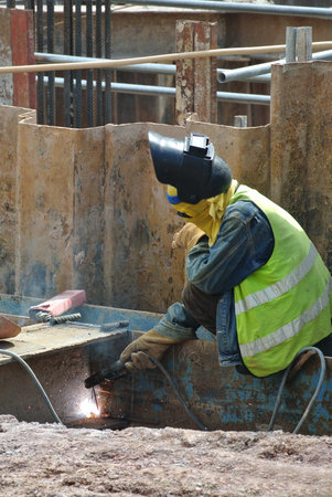 SELANGOR, MALAYSIA  DECEMBER 09, 2015: Welder wearing protective mask welding metal at the...