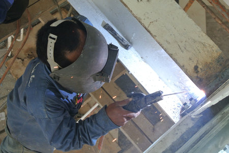 protective mask welding metal at the construction site.