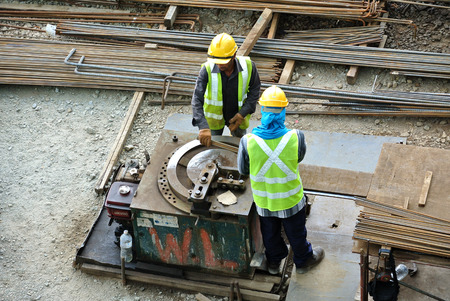 Construction workers working at the reinforcement bar bending yard in the construction site.のeditorial素材