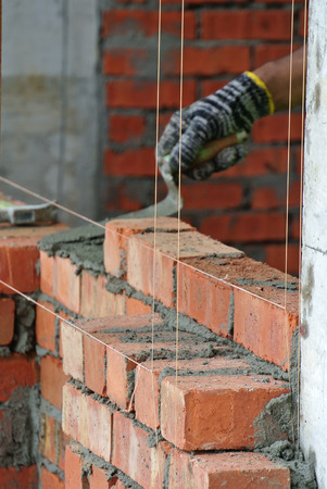 JOHOR, MALAYSIA -APRIL 05, 2016: Bricklayer install clay bricks for building walls.のeditorial素材