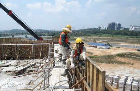 KUALA LUMPUR, MALAYSIA -JANUARY 15, 2017: Construction workers fabricating timber form work at the...