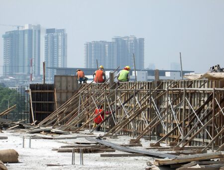 KUALA LUMPUR, MALAYSIA -JANUARY 15, 2017: Construction workers fabricating timber form work at the construction site. The form work was mainly made from timber and plywood.のeditorial素材