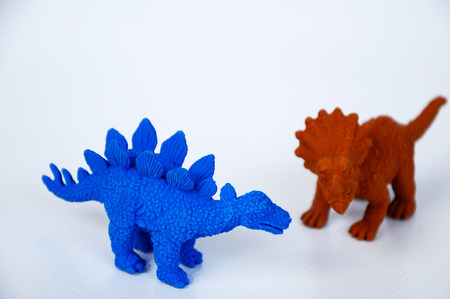 Triceratops and Stegosaurus dinosaur model made from brown and blue rubber isolated on white background.の写真素材