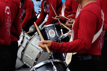 Brass band player is playing a musical instrument while guided by musical notes.のeditorial素材