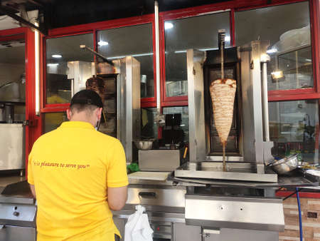 AMPANG, MALAYSIA - DECEMBER 2, 2020: Kebab or shawarma is sold by hawkers in small roadside shops as a takeaway dish. Wrapped with bread and a choice of meat or chicken as well as vegetables.のeditorial素材