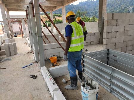 SEREMBAN, MALAYSIA -MARCH 17, 2020: Blockwork by construction workers at the construction site....