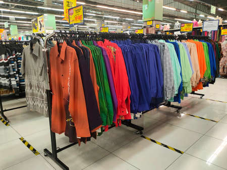 SEREMBAN, MALAYSIA -MARCH 2021: Various types of clothes are being sold in supermarkets. Displayed by hanging or placed in a container. Price tags are displayed for customer referenceの写真素材