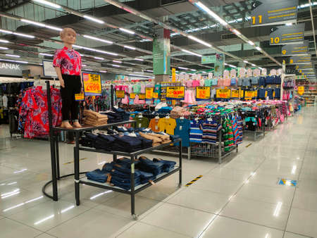 SEREMBAN, MALAYSIA -MARCH 2021: Various types of clothes are being sold in supermarkets. Displayed by hanging or placed in a container. Price tags are displayed for customer referenceのeditorial素材
