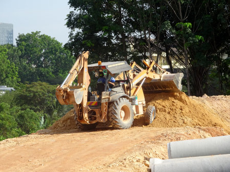 MALACCA, MALAYSIA -MARCH 5, 2020: Excavators machine at the construction site. It is used to...