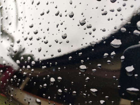 Selected focusing on raindrops and dew on black metal surfaces. These little drops will disappear when exposed to sunlight.の写真素材