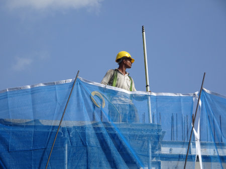 KUALA LUMPUR, MALAYSIA -JULY 16, 2020: Surveyor with survey equipment at the construction site. Surveyors help set the location and level at the construction site.のeditorial素材