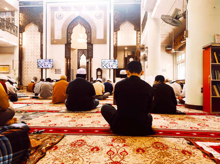 KUALA LUMPUR, MALAYSIA -AUGUST 14, 2020: The atmosphere in the mosque that practices social distancing while performing prayers during the Covid-19 pandemic. Muslim men are performing Friday prayers.のeditorial素材