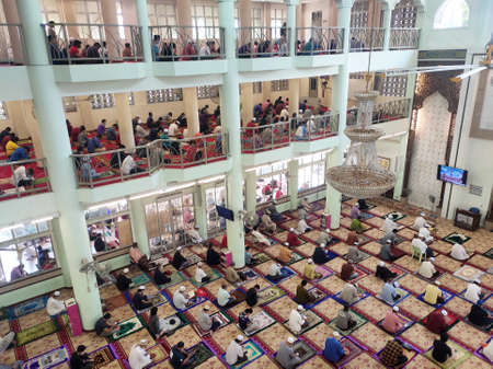 KUALA LUMPUR, MALAYSIA -AUGUST 14, 2020: The atmosphere in the mosque that practices social distancing while performing prayers during the Covid-19 pandemic. Muslim men are performing Friday prayers.のeditorial素材
