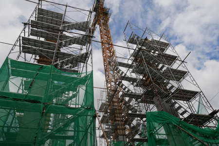 SEREMBAN, MALAYSIA -MAY 24, 2020: Temporary access and metal staircase made from staging, scaffolding and metal platform. Workers used it at the construction site to work at height.のeditorial素材