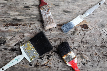 Old paintbrush on old wood board.