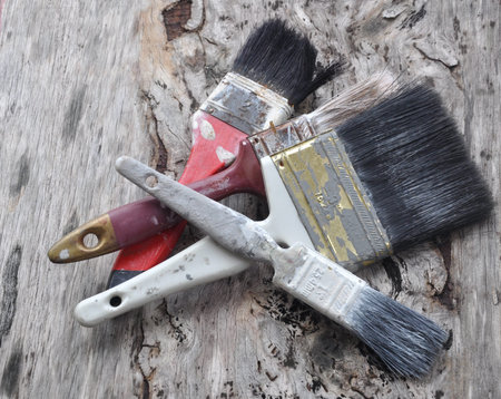 Old paintbrush on old wood board.