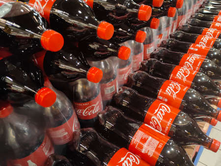KUALA LUMPUR, MALAYSIA -OCTOBER 15, 2021: Coca-cola drinks in large bottles are displayed for sale in a large supermarket. Placed in large quantities based on the high demand.のeditorial素材