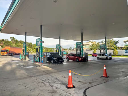 KUALA LUMPUR, MALAYSIA -MARCH 02, 2020: Petronas petrol station during the daytime. Customers come to visit this petrol station to refuel, buy groceries or use the facilities provided.のeditorial素材