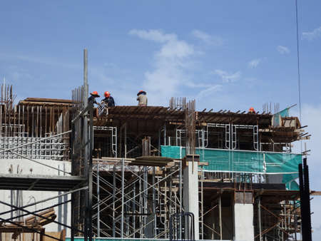 SEREMBAN, MALAYSIA -MARCH 7, 2020: Steel reinforced concrete structure is built at the construction site. Built using formworks made of wood and plywood. Manually build by the workers.のeditorial素材