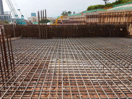 KUALA LUMPUR, MALAYSIA -MARCH 3, 2020: Building floor slab under construction. Construction workers fabricating the timber formwork and installing the steel reinforcement bar.のeditorial素材