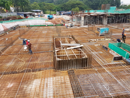 KUALA LUMPUR, MALAYSIA -MARCH 3, 2020: Building floor slab under construction. Construction workers...
