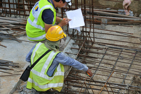MALACCA, MALAYSIA -MAY 9, 2017: Construction workers having a discussion at the construction site....