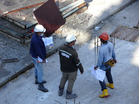 MALACCA, MALAYSIA -MAY 9, 2017: Construction workers having a discussion at the construction site....