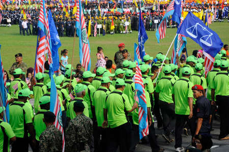 SEREMBAN, MALAYSIA -AUGUST 31, 2017: Members of political party Barisan National holding Barisan National flag during Malaysia Independence Day Parade. BN is the biggest political party in Malaysia.のeditorial素材