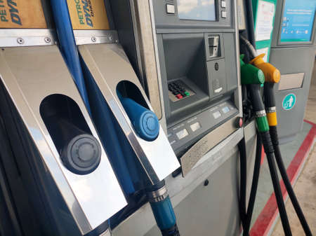 KUALA LUMPUR, MALAYSIA -MARCH 26, 2020: Fuel nozzle used to pumping petrol into a vehicle at the petrol station. Nozzles should be put in place when not in use.のeditorial素材