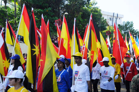PUTRAJAYA, MALAYSIA -AUGUST 31, 2019: Malaysian teenagers from various ethnics marching on the road while holding Malaysian state flags during The Malaysia Independent parade.のeditorial素材