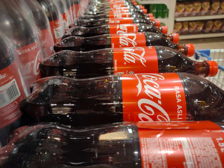 KUALA LUMPUR, MALAYSIA -OCTOBER 15, 2021: Coca-cola drinks in large bottles are displayed for sale in a large supermarket. Placed in large quantities based on the high demand.のeditorial素材