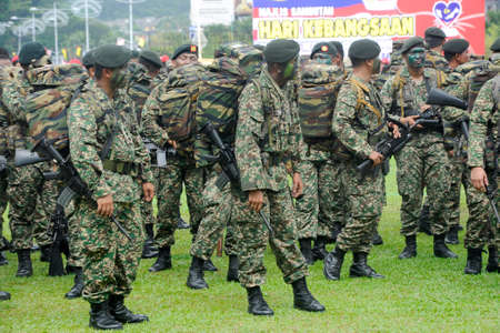 SEREMBAN, MALAYSIA -AUGUST 31, 2016: Malaysia Royal Malay Regiment in full uniform and armed during and after joining the Malaysia National Day parade 2016.のeditorial素材