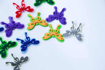 Images of butterflies made of colourful felt fabrics. Isolated on white background.