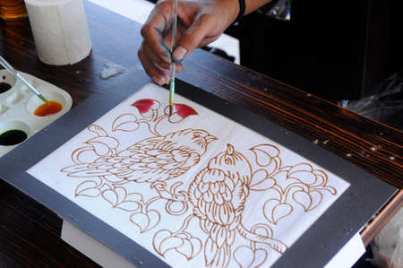 Malaysian draw batik or batik canting. The color control by wet wax that drawn earlier.の写真素材